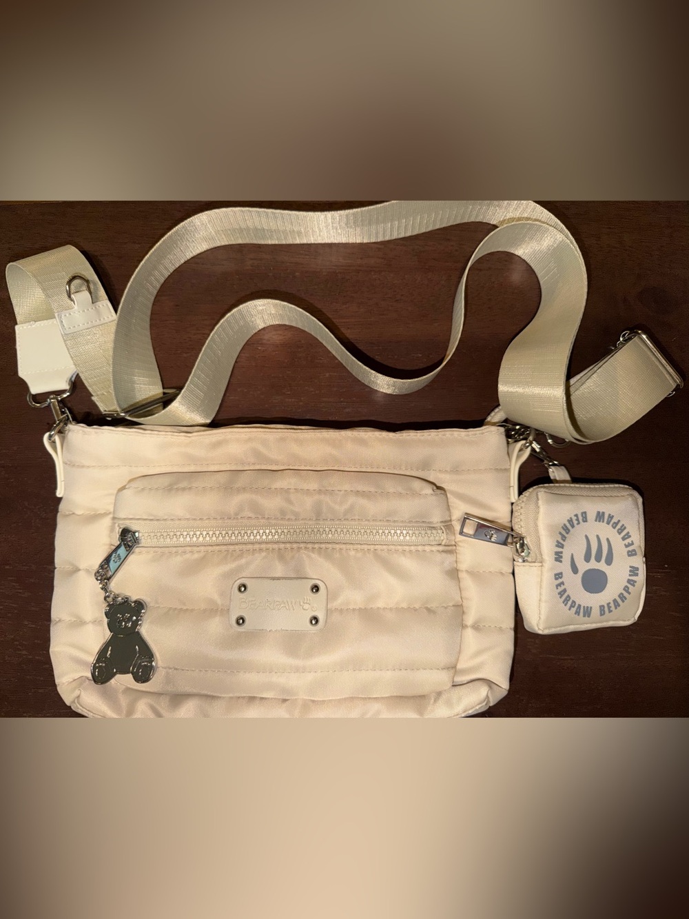 BearPaw Cream Quilted Crossbody Bag: Front Zip Pocket, Coin Purse, & Bear Charm